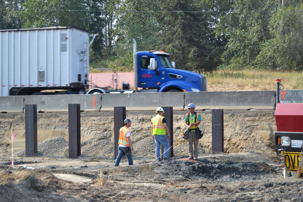 Crewmen under contract with the Department of Transportation stand atop a culvert for Matriotti Creek on Aug. 8 that will be replaced with a larger one to increase fish passage and habitat. Sequim Gazette photo by Matthew Nash