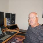 Sequim musician and music-tech educator Mike Klinger sits at his desk in his home music studio demonstrating how to use music and technology together. Sequim Gazette photo by Erin Hawkins