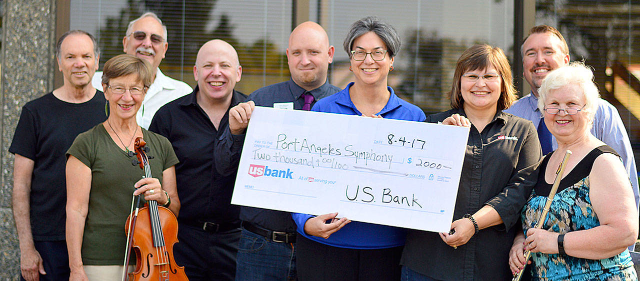 US Bank in Port Angeles presents a donation to the Port Angeles Symphony earlier this month. From left are Adventures in Music director Al Harris, violinist Hilde Martin, symphony board member Tom O&rsquo;Donnell, conductor Jonathan Pasternack, US Bank&rsquo;s Chris Benson, Lisa Meyer, Carlyne Littlejohn and Ernie Allen and symphony president Marie Meyers. Photo courtesy of Port Angeles Symphony