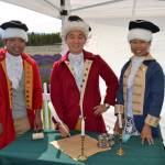 Friends from Seattle, from left, Peter Cher, Jung Jim and Jin Lim dress the part for a photo-op as they prepare to sign the Declaration of Independence. Lim said wasn&rsquo;t able to make Sequim Lavender Weekend so she came up for the NW Colonial Festival. Sequim Gazette photo by Matthew Nash