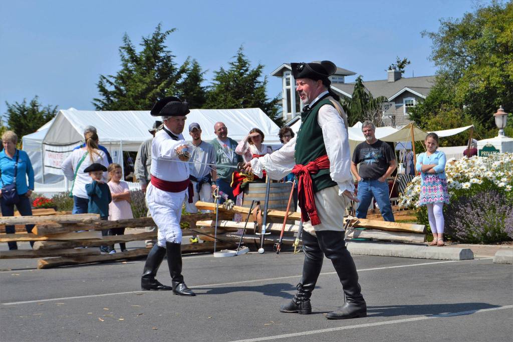 Jack Pauly as Sir John Redmayne, left, demonstrates a duel with David Wine as Lt. Peter Ten Brock in front of the George Washington Inn. They showed different swords from the time period and before.