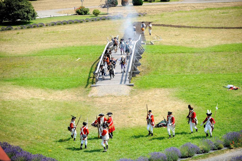 Volunteers recreate the &ldquo;Battle for Concord Bridge&rdquo; by the George Washington Inn. They acted out the battle four times each day during the NW Colonial Festival Aug. 10-13. Sequim Gazette photos by Matthew Nash