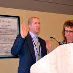 Sequim City Manager Charlie Bush, seen taking his oath of office on Aug. 24, 2015, from Sequim City Clerk Karen Kuznek-Reese, recently received a positive review from Sequim city councilors and a raise. Sequim Gazette photo by Matthew Nash