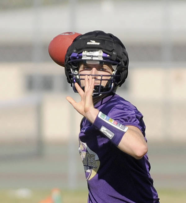 Junior quarterback Riley Cowan looks for a receiver in an early preseason drill. Sequim Gazette photo by Michael Dashiell