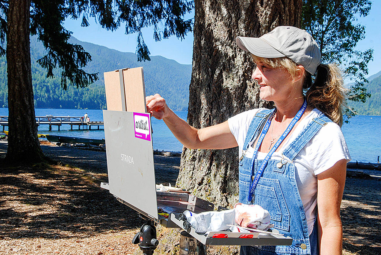 Romona Youngquist of Newberg, Ore., paints at Lake Crescent during the 2016 Paint the Peninsula competition. Photo courtesy Port Angeles Fine Arts Center