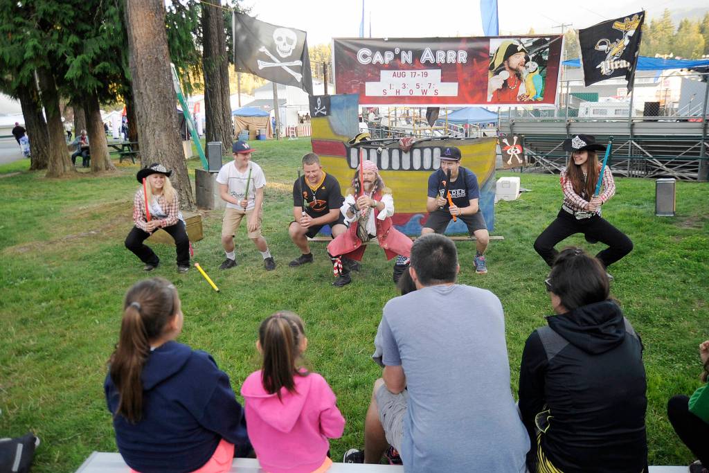 Captain Arrr leads fair-goers in some Pirate-themed yoga, including Clallam County Fair Queen Janeydean O&rsquo;Connor of Sequim, far right, and fair Princess Marykate Napiontek of Port Angeles, far left. Sequim Gazette photo by Michael Dashiell