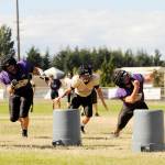 Sequim coach Erik WIker (far left) leads a linebacker drill at a Sequim preseason practice last week. Sequim Gazette photos by Michael Dashiell