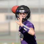 Junior quarterback Riley Cowan looks for a receiver in an early preseason drill.