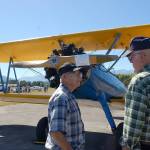 John Denny from south of Seattle, left, chats with Patrick Nolan of the Sequim area about a 1942 PT-17 Stearman restored as a World War II trainer plane owned by the Port Townsend Aero Museum. Sequim Gazette photo by Erin Hawkins