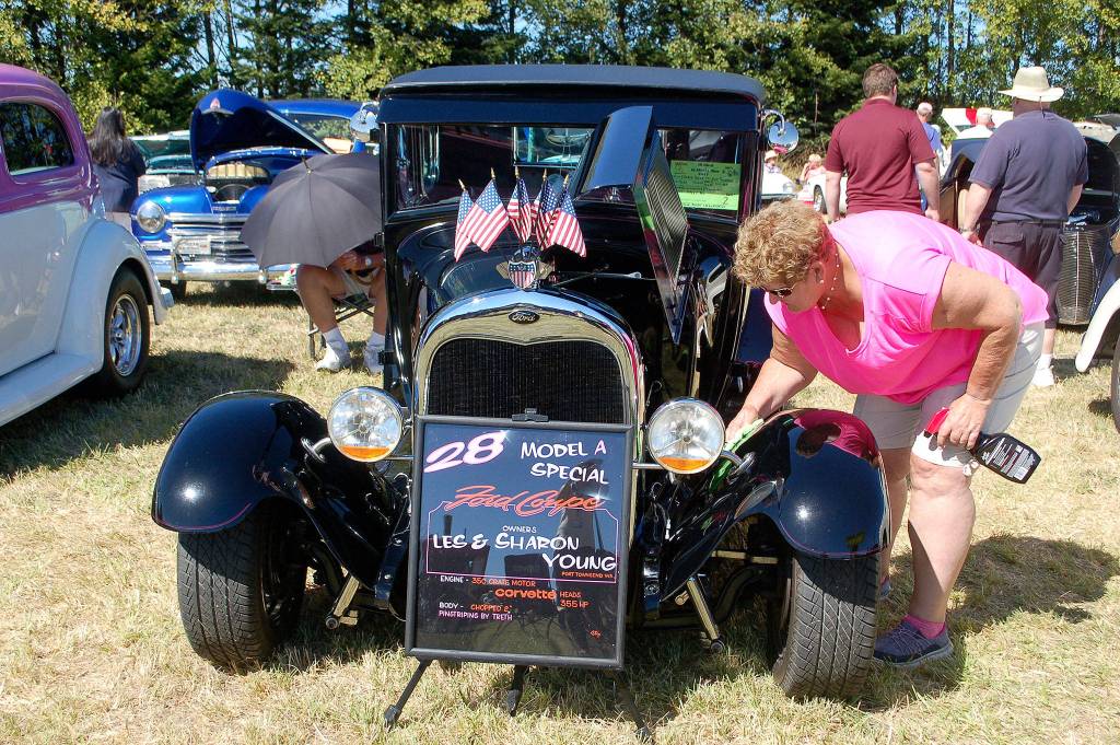 Sharon Young of Port Townsend polishes her 1928 Model A Ford street rod on display at the car show at the Olympic Peninsula Air Affaire.