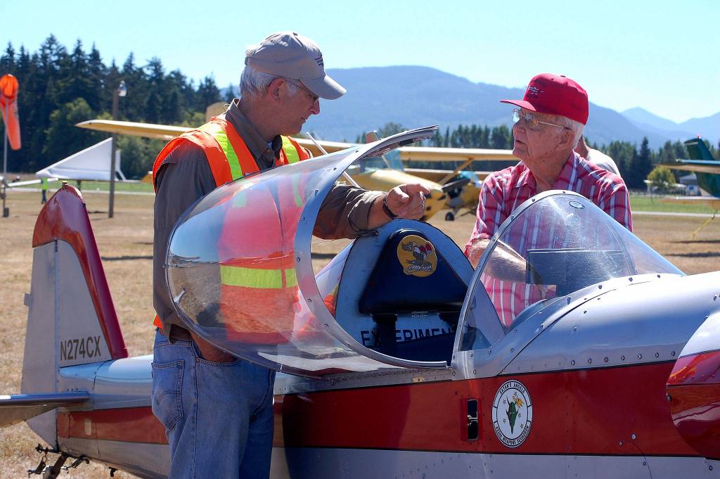 Sequim Experimental Aircraft Association member Harry Cook, left, chats with airplane owner Brad Sharp.