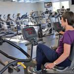 Mary Farley of Sequim and Linda Flores of Port Angeles cycle at the YMCA of Sequim on Aug. 28 during a workout with the Exercise and Thrive program. Sequim Gazette photo by Matthew Nash