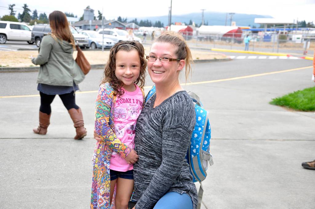 First-grader Shaye Ball arrives at Greywolf Elementary on Aug. 30 for the first day of school, all smiles, with her mom. Photo by Patsene Dashiell