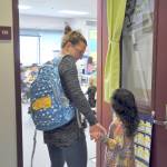 First-grader Shaye Ball enters her new classroom with mom on the first day of school. Photo by Patsene Dashiell