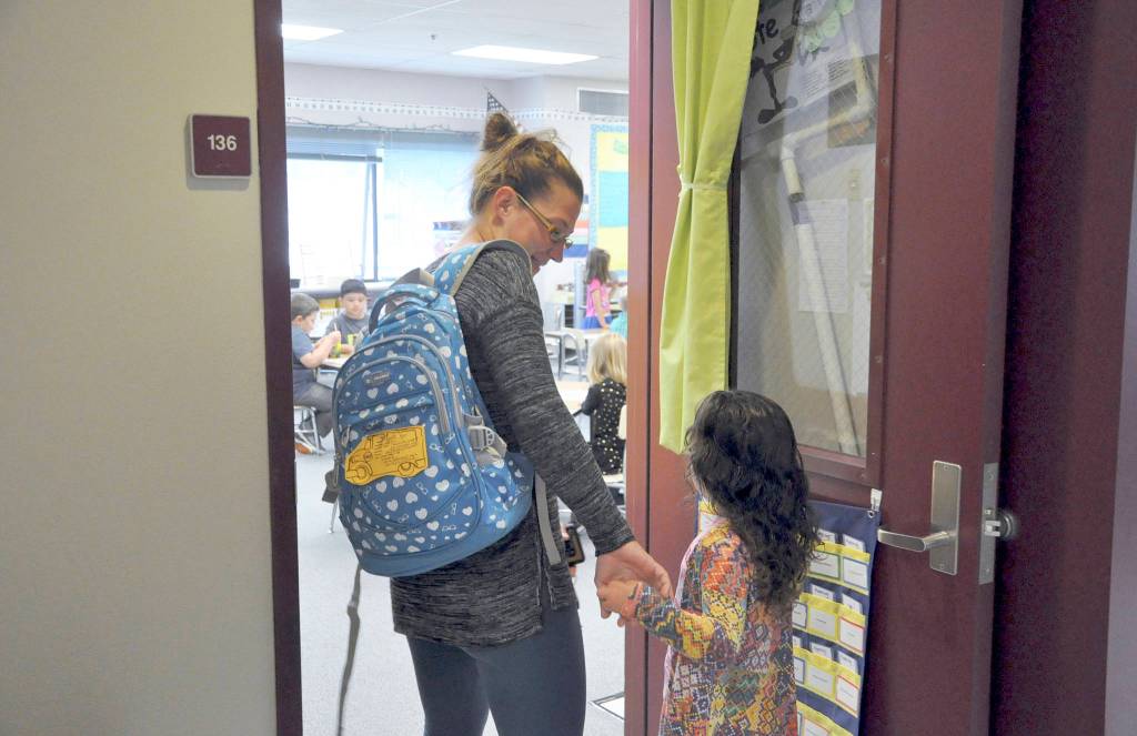 First-grader Shaye Ball enters her new classroom with mom on the first day of school. Photo by Patsene Dashiell