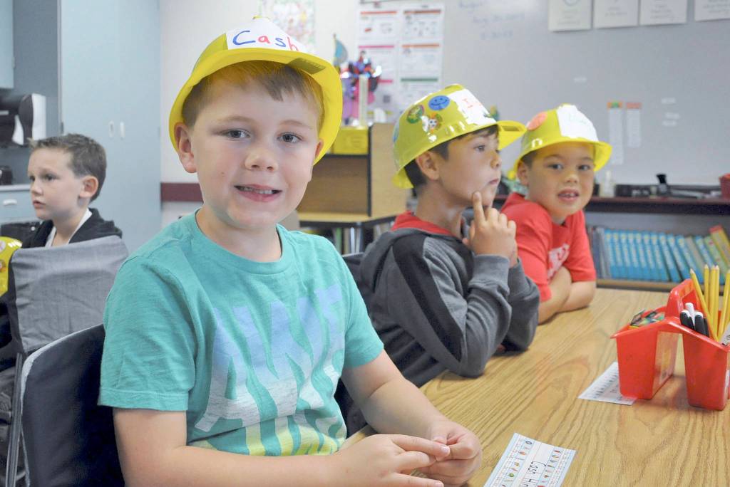 Greywolf Elementary School first-graders (from left) Cash Hiner, Isaiah Gradillas and Hunter Carlile are seated at their places and ready to begin the new school year.