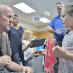 During Back to School Night, Sophie Clayton &mdash; a second-grader at Helen Haller Elementary School &mdash; shares with science specialist Dave Hasenpflug that she wants to become a veterinarian to &ldquo;take care of small, furry animals.&rdquo; Photo by Patsene Dashiell