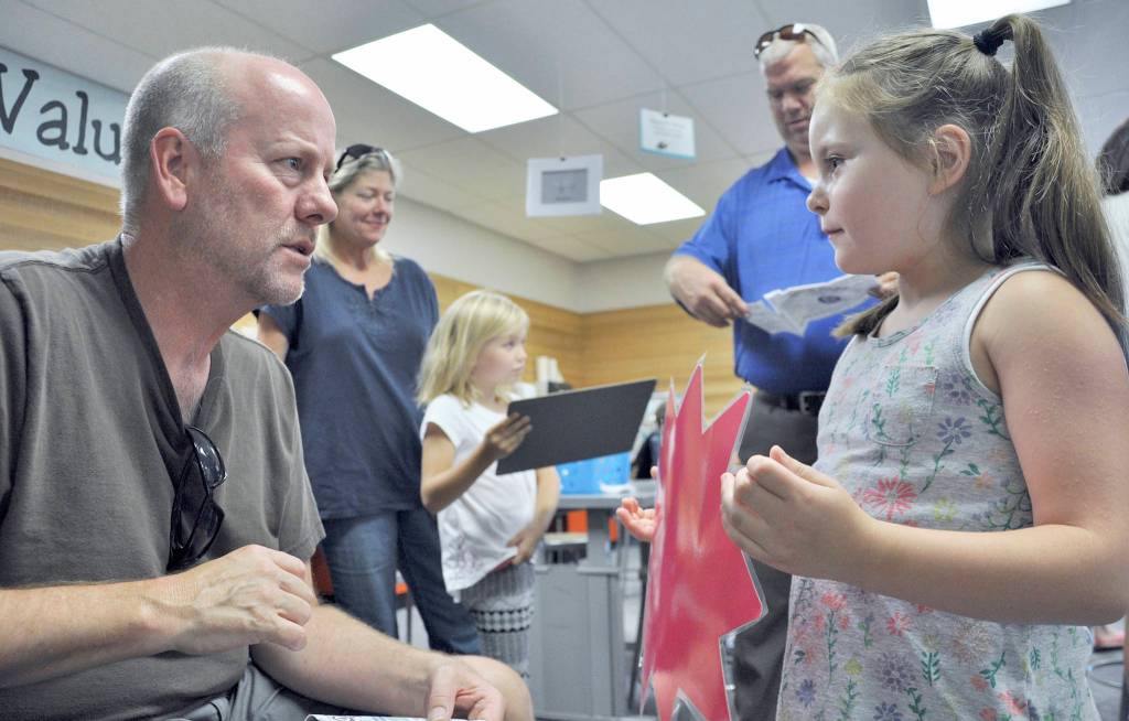 During Back to School Night, Sophie Clayton &mdash; a second-grader at Helen Haller Elementary School &mdash; shares with science specialist Dave Hasenpflug that she wants to become a veterinarian to &ldquo;take care of small, furry animals.&rdquo; Photo by Patsene Dashiell