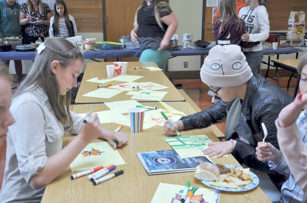 Olympic Peninsula Academy eighth-graders Sydnei Frymyer, left, and Faith Amaya complete a drawing assignment during Otter Day, a prelude to the first day of class on Sept. 5. Photo by Patsene Dashiell