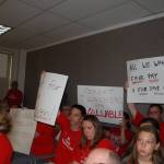A group of supporters raise their signs advocating for fair teacher pay during the Sequim school board meeting on Tuesday, Sept. 5, at the Sequim High School auditorium as Sequim school district remains in mediation with the teachers&rsquo; union. Sequim Gazette photo by Erin Hawkins
