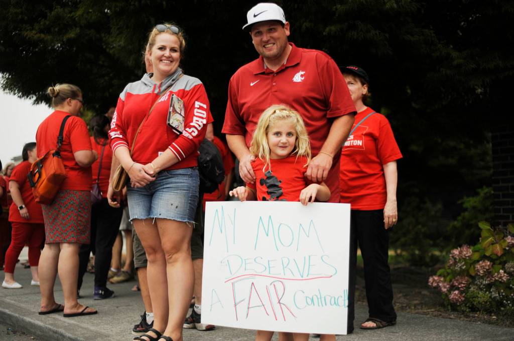 Kaylee Kinsey, a Helen Haller Elementary School teacher, and fiancé Kyler McCaslin and Kinsey&rsquo;s daughter Pepper Giffin, a kindergartner at Helen Haller, join Sequim staffers outside the Sequim School District boardroom on Sept. 5. Sequim Gazette photo by Michael Dashiell
