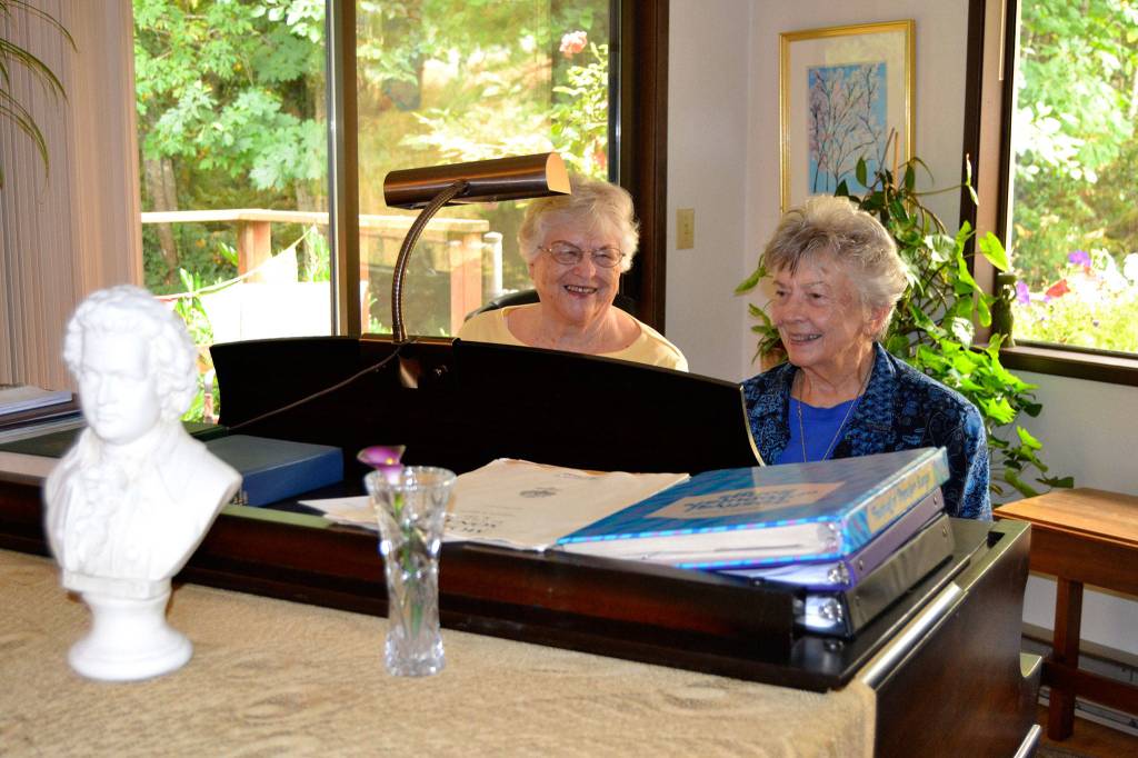 Elizabeth Kelly of Port Angeles, left, says her best friend JoAnn Fisher of Sequim inspired her to learn to play the piano. At 85, Kelly continues to give lessons. Sequim Gazette photo by Matthew Nash