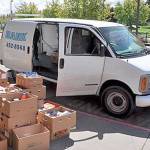 North Olympic Library System employees load a food bank van during the 2013 Food for Fines Program. Submitted photo