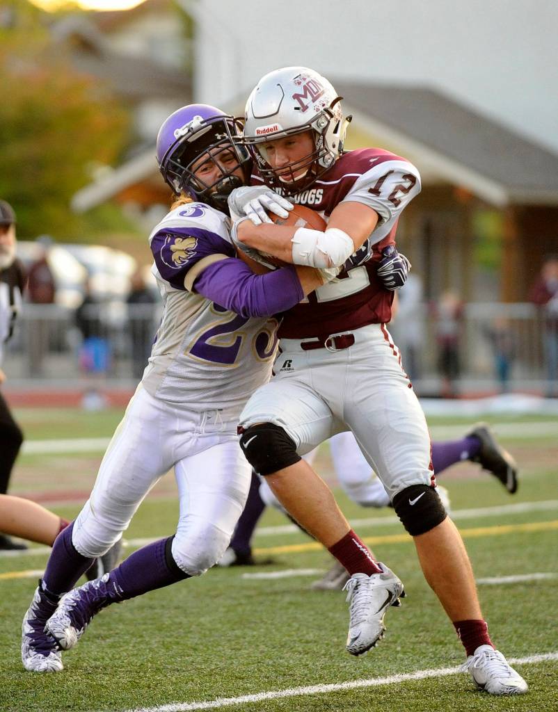 Sequim defensive back Gavin Velarde, left, makes a stop on Montesano&rsquo;s Sam Winter in the first quarter of Sequim&rsquo;s non-league match-up with Montesano. The host Bulldogs beat Sequim&rsquo;s Wolves, 41-6. Sequim Gazette photo by Michael Dashiell