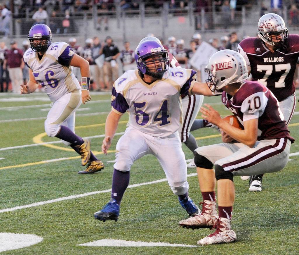 Sequim High defensive end Adam DeFillipo (54) looks to make a stop on Montesano quarterback Trevor Ridgway. Sequim Gazette photo by Michael Dashiell