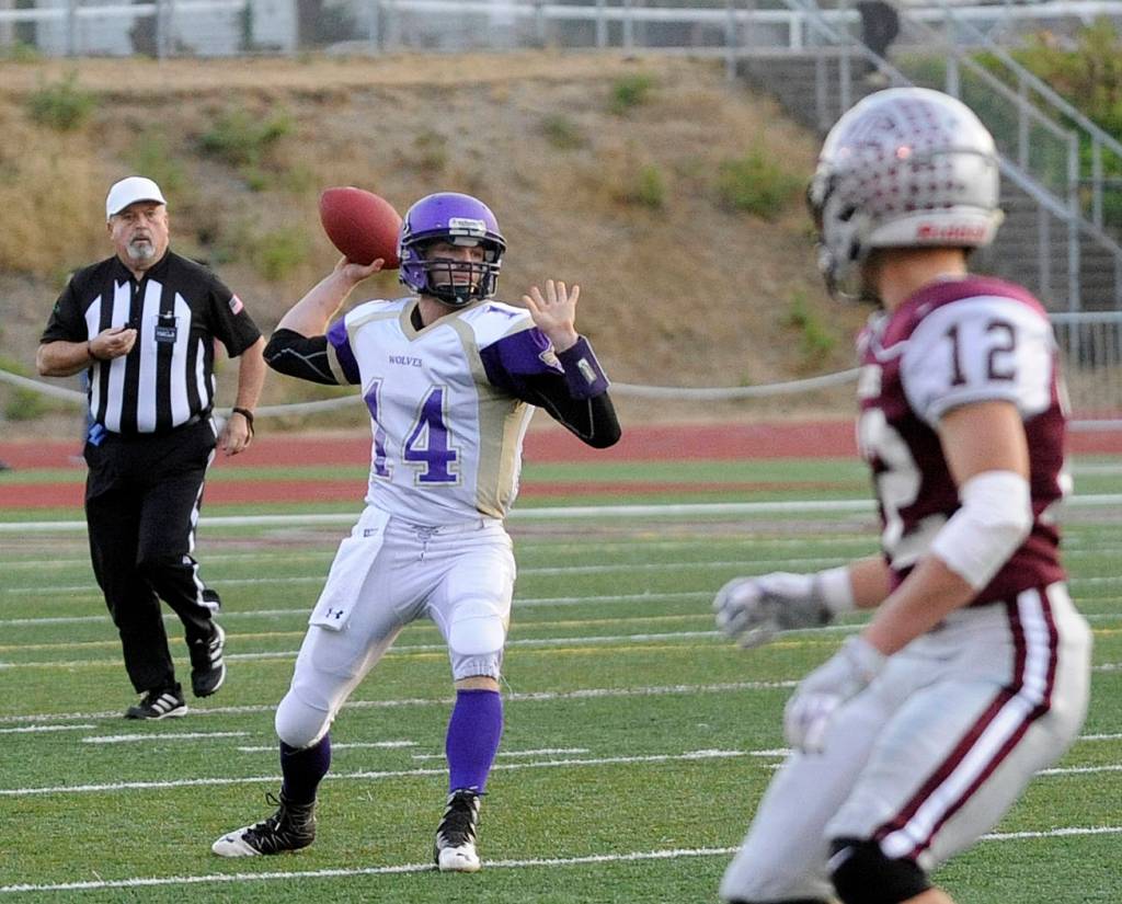 SHS quarterback Riley Cowan looks for a receiver downfield in the first quarter of the Wolves&rsquo; Sept. 8 game at Montesano. Sequim Gazette photo by Michael Dashiell