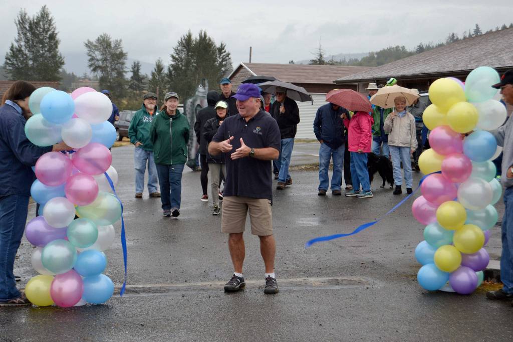 Mayor Dennis Smith for the City of Sequim cuts the ribbon to start the Dungeness Valley Health and Wellness Clinic&rsquo;s Fun Walk on Sept. 9 at Trinity United Methodist Church. Sequim Gazette photo by Matthew Nash