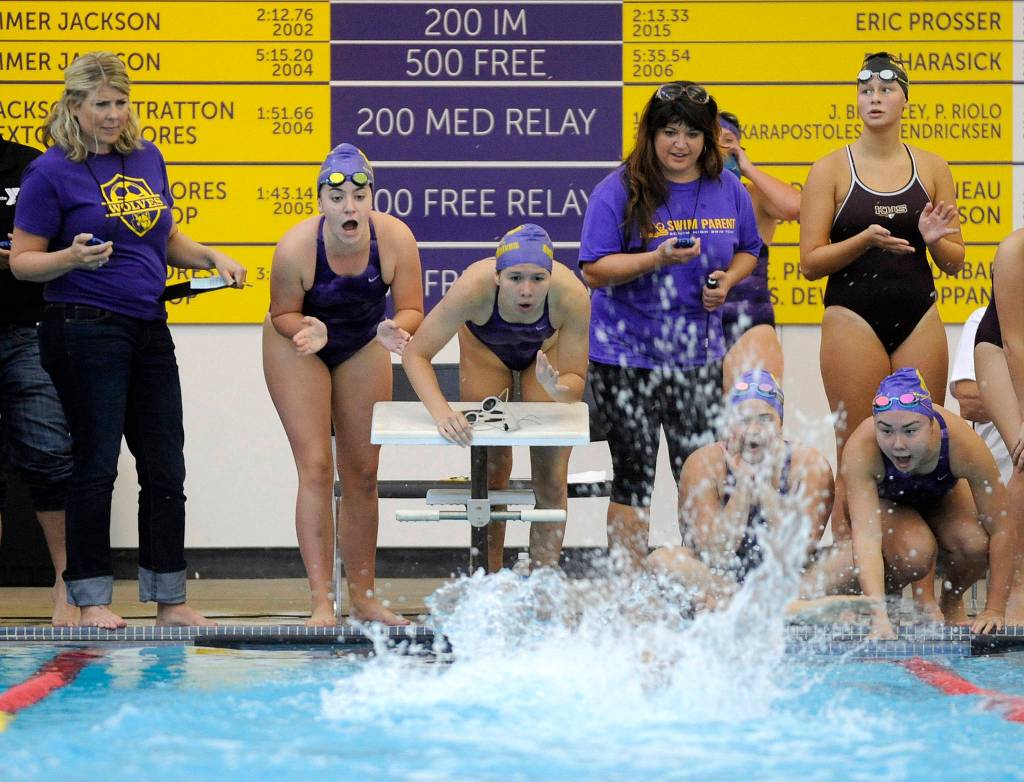 Teammates cheer on the anchor of Sequim&rsquo;s 200 medley relay team that clocked in at 2:01.54 &mdash; about a half-second under a state 2A meet qualifying time &mdash; as the Wolves take on Kingston on Sept. 14. The relay squad includes Sydnee Linnane, Sydney Swanson, Sonja Govertson and Jasmine Itti. Sequim Gazette photo by Michael Dashiell
