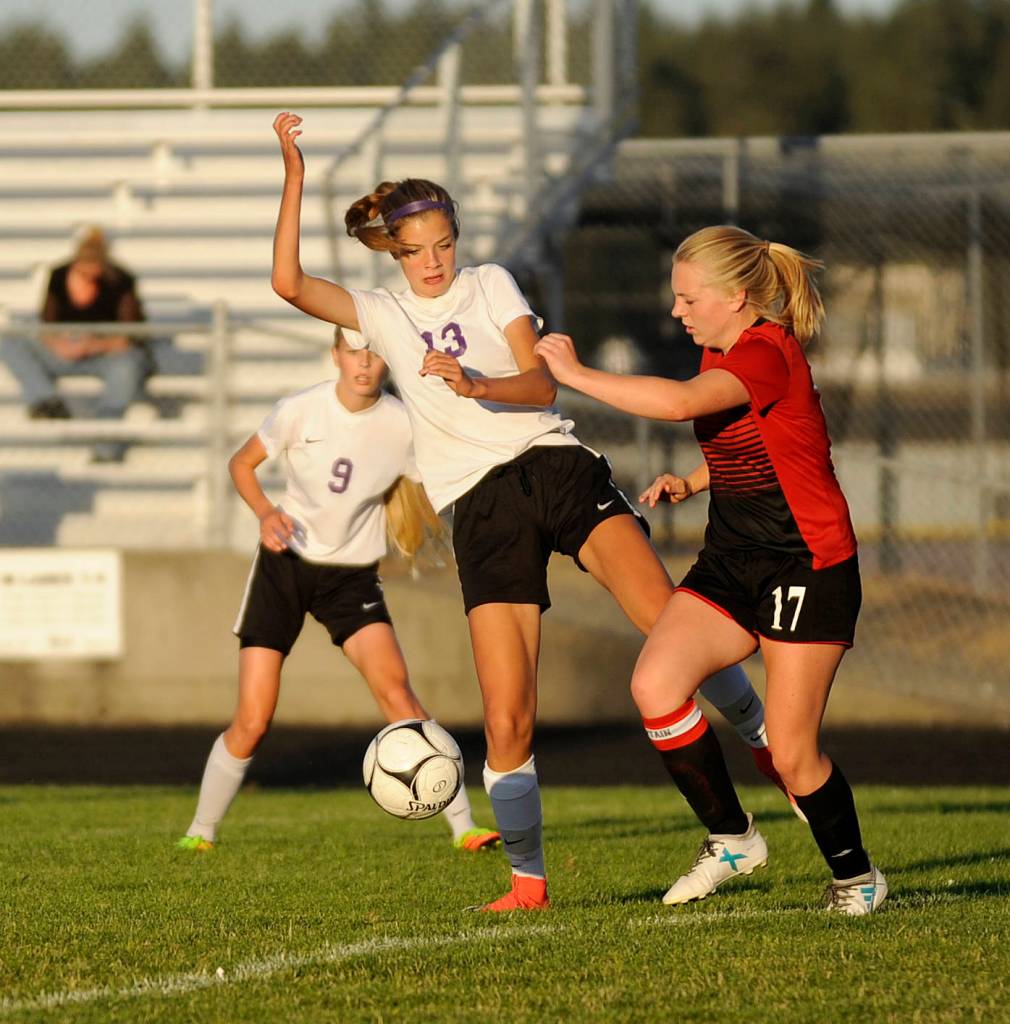 Sequim sophomore Mikayla Geniesse (13) and Coupeville senior Sage Renninger battle for the ball on Sept. 14. Sequim Gazette photo by Michael Dashiell