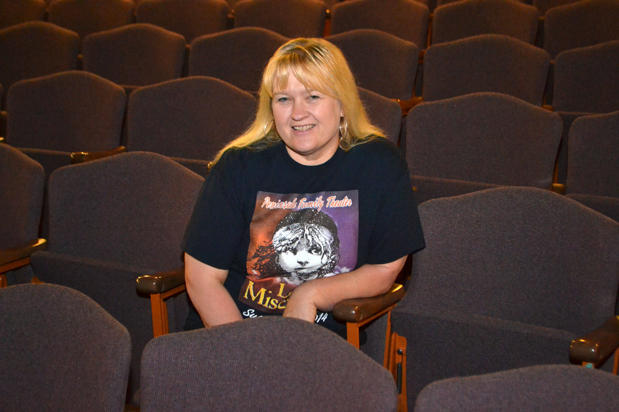 Robin Hall, 53, sits in the auditorium at Sequim High School in 2014 where she&rsquo;s officially led plays for the school since 2011. A few weeks ago her contract wasn&rsquo;t renewed because the school district now requires after school instructors like her to hold a teaching certificate. Sequim Gazette file photo by Matthew Nash
