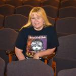 Robin Hall, 53, sits in the auditorium at Sequim High School in 2014 where she&rsquo;s officially led plays for the school since 2011. A few weeks ago her contract wasn&rsquo;t renewed because the school district now requires after school instructors like her to hold a teaching certificate. Sequim Gazette file photo by Matthew Nash