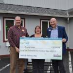 The Shipley Center&rsquo;s Executive Director Michael Smith and Development and Programs Director Michelle Rhodes accept a check from Brian Jackson, franchise owner of Home Instead Senior Care of the Olympic Peninsula, for winning the Home Instead Senior Care Foundation&rsquo;s GIVE65 campaign in July. Funds will go to the center&rsquo;s proposed annex.