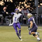 Sequim quarterback Riley Cowan, left, looks for a receiver as North Kitsap&rsquo;s Connor Westby provides pressure. Westby sacked Cowan twice in NK&rsquo;s 42-0 win on Sept. 29 in Poulsbo. Sequim Gazette photo by Michael Dashiell