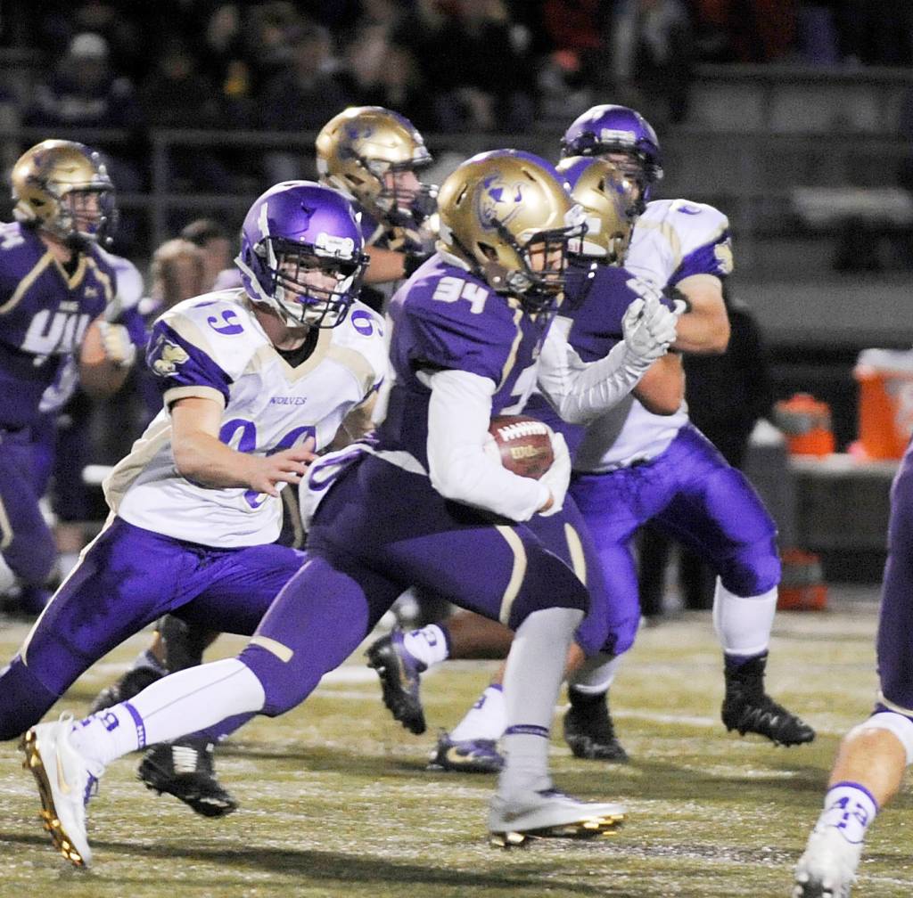 Sequim&rsquo;s Ben Cowan, left, looks to tackle North Kitsap running back Clayton William in the second half of NK&rsquo;s league win over the Wolves last week. Sequim Gazette photo by Michael Dashiell