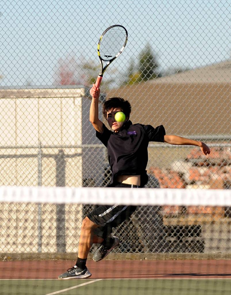 Sequim&rsquo;s Raymond Lam looks to return a serve as he takes on Kenny Soule, Port Angeles&rsquo; No. 1 singles player, on Oct. 5. Photo by Michael Dashiell/Sequim Gazette