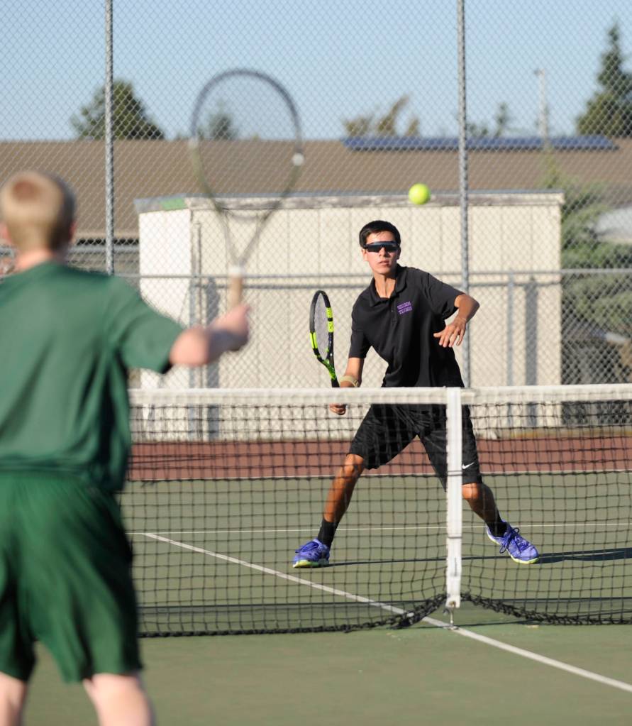 Sequim&rsquo;s Blake Wiker looks to return a shot as he and teammate Thomas Hughes take on Port Angeles&rsquo; Brady Nickerson and Kyler Tourbin on Oct. 5. Photo by Michael Dashiell/Sequim Gazette