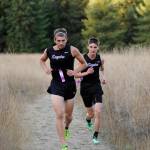 Sequim&rsquo;s Alec Shingleton, left, and Jazen Bartee race up the meadow hill at Robin Hill County Park last week. Shingleton placed third and Bartee was fourth as the Wolves easily won the double-dual Olympic League meet. Sequim Gazette photo by Michael Dashiell
