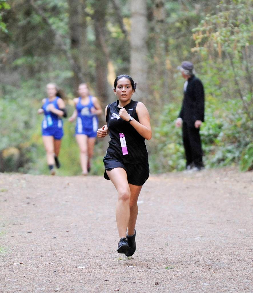 Sequim&rsquo;s Nathalie Arreguin races to a strong finish as she helps the Wolves escape with a one-point win over North Mason on Oct. 4. Sequim Gazette photo by Michael Dashiell