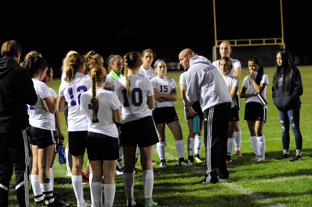 Sequim Coach Derek Vander Velde speaks to the Wolves at halftime trying to energize them against the Olympic Trojans. Sequim Gazette photo by Matthew Nash