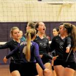 Sequim&rsquo;s Arlene Law (center) celebrates another Sequim point in a 3-1 win over the visiting Olympic Trojans on Oct. 5. Law had 13 kills and two blocks in the win. Sequim Gazette photo by Matthew Nash