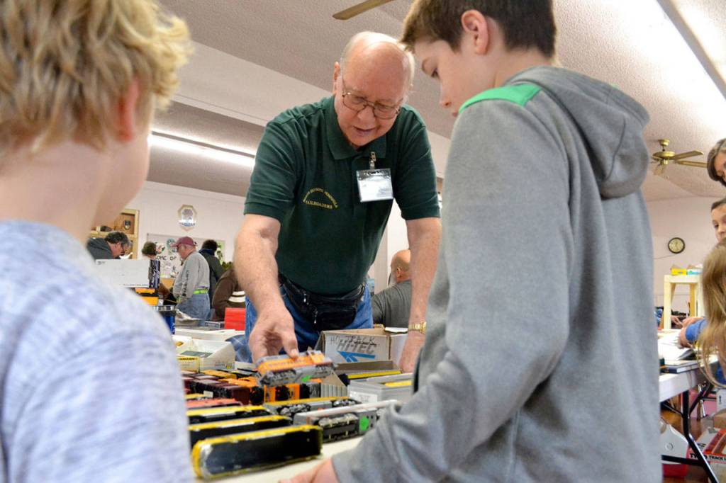 Richard Bell with the North Olympic Peninsula Railroaders speaks with brothers Ben and Jack Clemens of Port Angeles at the club&rsquo;s annual Trains Show and Swap Meet last year. The show continues this Saturday-Sunday at the Sequim Prairie Grange. Sequim Gazette file photo by Matthew Nash