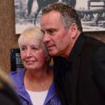 Betty Hendricks and Ethan Wayne stand together Saturday during the dedication of a room at John Wayne Marina in honor of Hendricks&rsquo; late husband, Jerry Hendricks, a former Port of Port Angeles executive director. (Jesse Major/Peninsula Daily News)