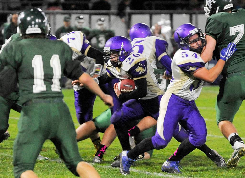 Sequim&rsquo;s Hayden Gresli burst through the line for a big gain in Sequim&rsquo;s 29-14 win at Port Angeles on Oct. 20. Gresli tallied 97 yards and two touchdowns. Sequim Gazette photo by Michael Dashiell