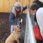 WAG volunteer Glen Varvil and 3-year-old Rosie greet visitors to the organization&rsquo;s open house on Oct. 28.