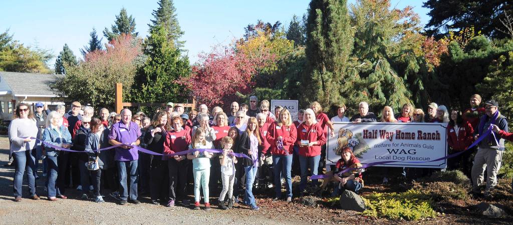 Volunteers and supports of the Welfare for Animals Guild celebrate the opening of WAG&rsquo;s new Half Way Home Ranch on Oct. 28. Sequim Gazette photo by Michael Dashiell