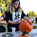 Angel Wagner, 12, of Sequim, carves Jack the Pumpkin King from &ldquo;The Nightmare before Christmas.&rdquo; Angel said she attends the Sequim Prairie Grange&rsquo;s Pumpkin Party each year. Grange members also hosted a Country Fair inside with games and treats.